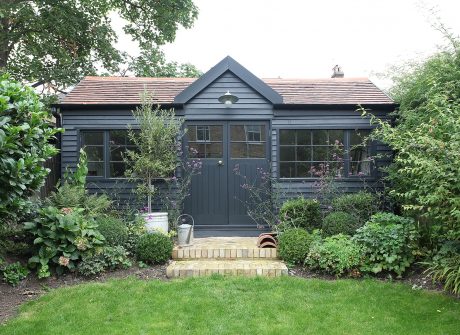 Beautiful summerhouse in pretty garden with double doors and wooden windows