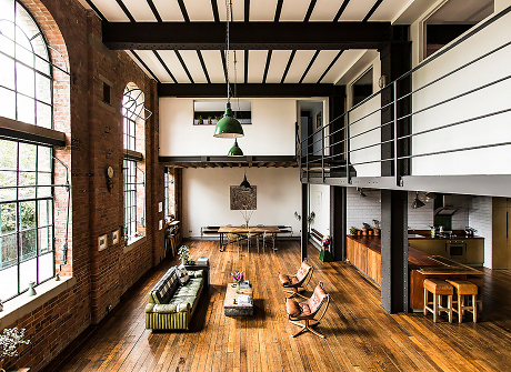 Very large living/kitchen space with large windows at restored Victorian warehouse