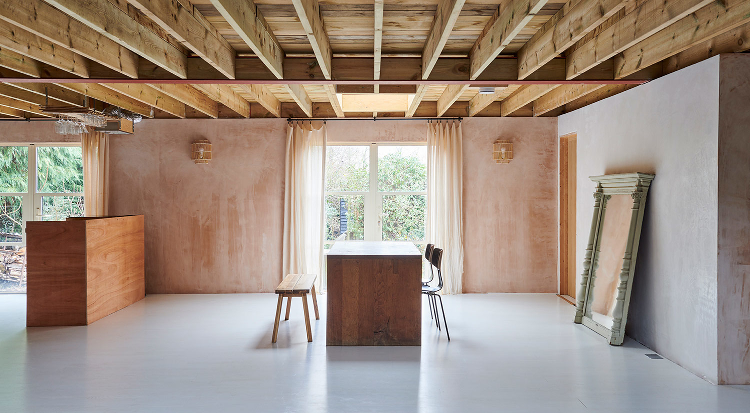 Large open plan space with exposed beams and ceiling rafters in a single storey house near Rye