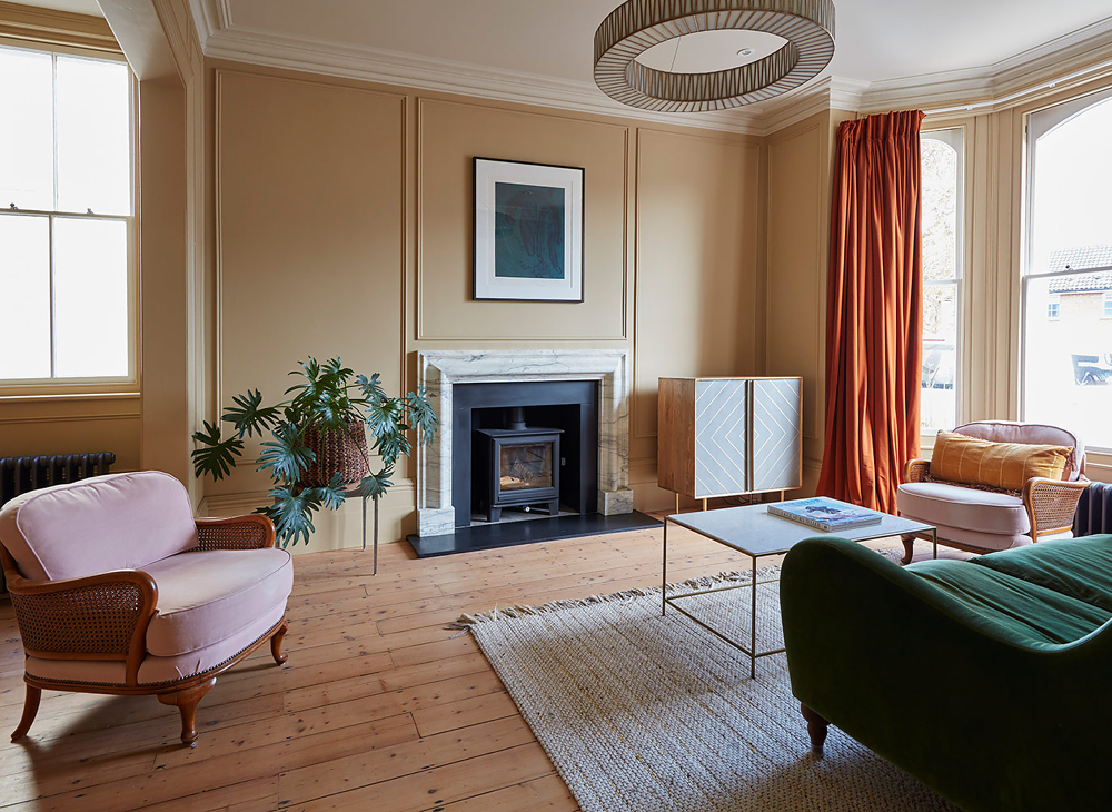 Living room with bay windows, double doors and marble fireplace