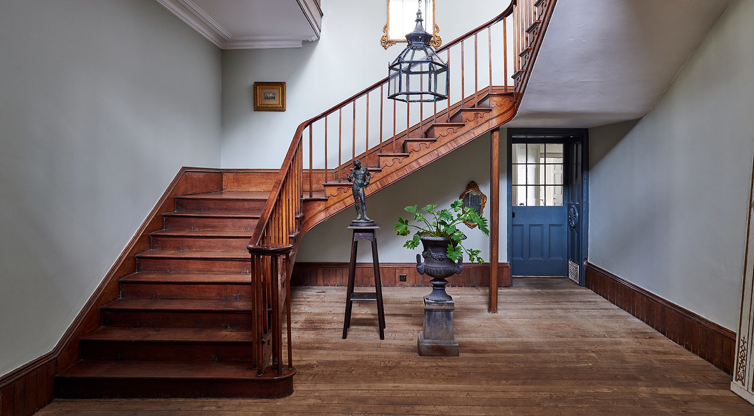 Beautiful hallway with sweeping staircase in a stunning Georgian 4-bedroom farmhouse in Somerset